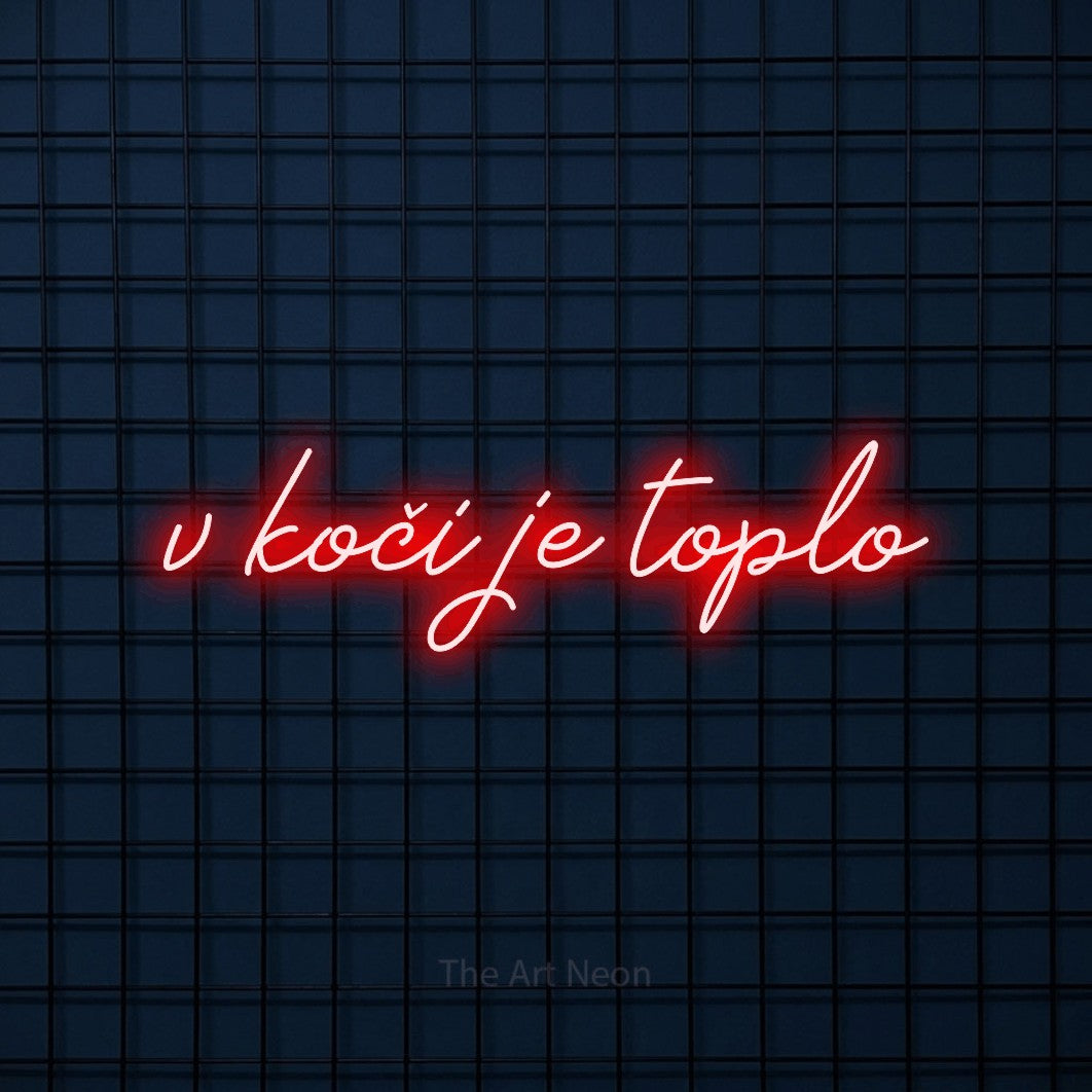 LED neon sign reading “v koči je toplo”, arranged in a single line.