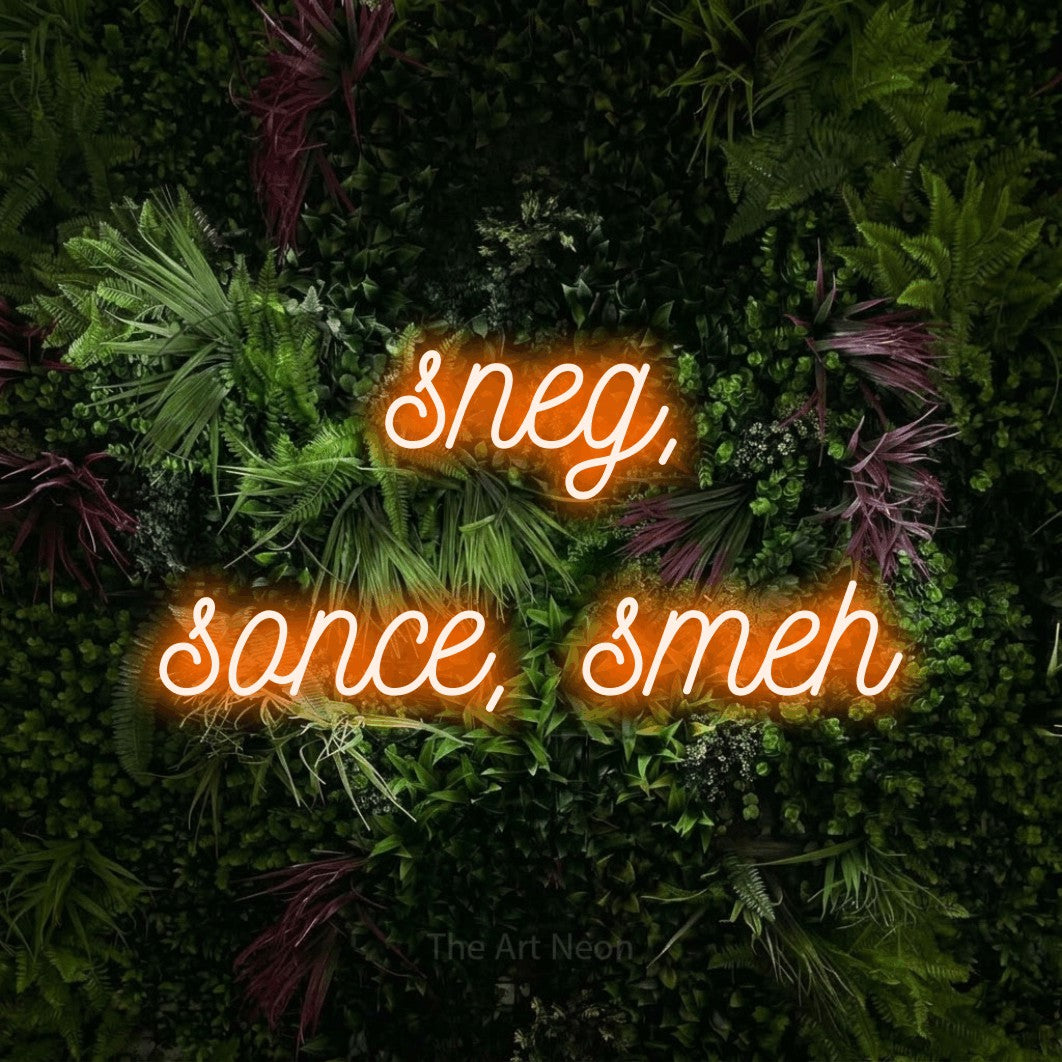 LED neon sign reading “sneg, sonce, smeh”, arranged in two lines.