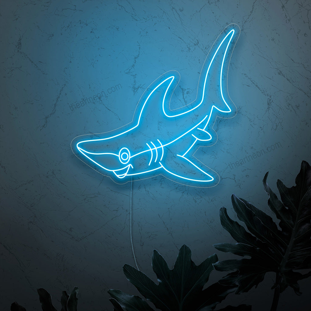 A smiling shark neon sign, radiating vibrant and mesmerizing glow, adding a playful charm and electrifying presence to any space.