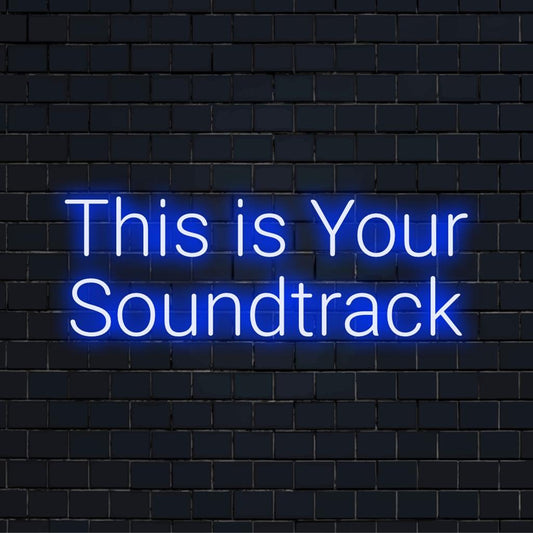 A vibrant LED neon sign with the phrase This Is Your Soundtrack, perfect as personalized neon wall art or decor.