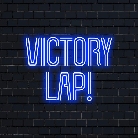 Custom neon sign with the phrase Victory Lap! in bright colors, illuminates any space, perfect as personalized neon decor.