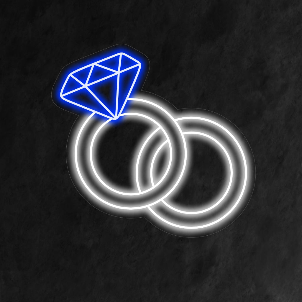 "Wedding Rings Neon Sign" sümboliseerib pehme säraga igavest armastust, luues romantilise õhkkonna, mis tähistab kahe südame liitu.