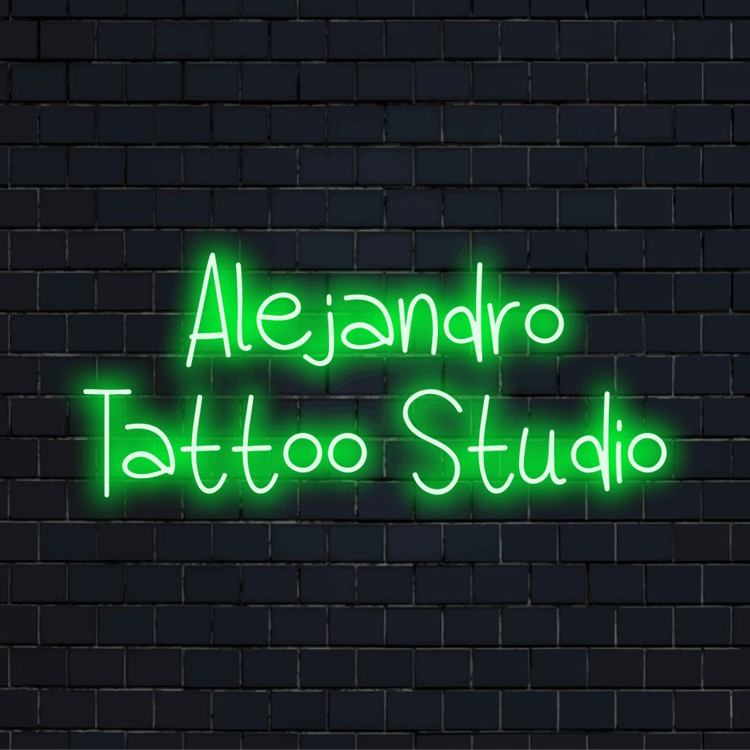 Alejandro Tattoo Studio Custom Name Neon Sign, glowing neon text against brick backdrop
