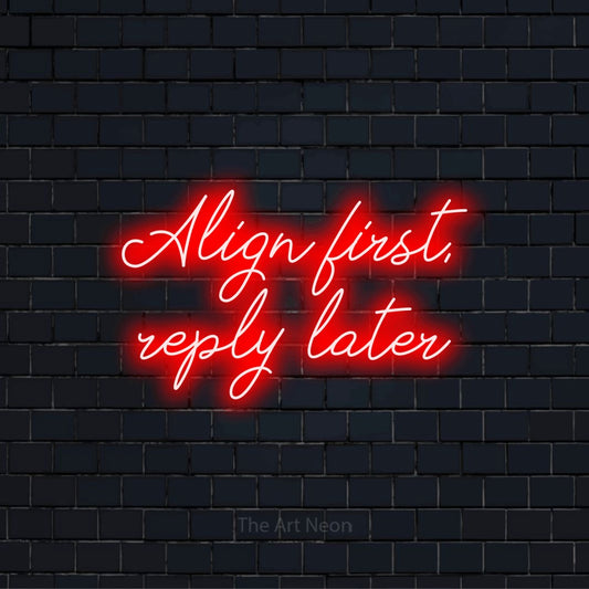 "Align First, Reply Later" script-style LED neon sign on a black brick wall