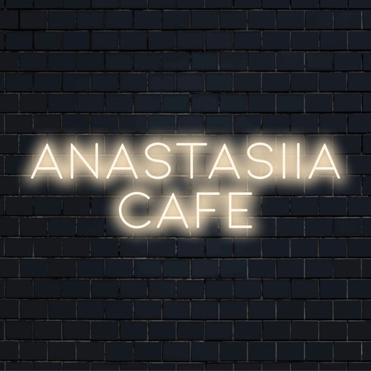 Anastasiia Cafe Personalized LED Neon Sign, glowing lettering against black brick wall