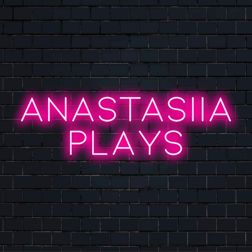 Anastasiia Plays Personalized Neon Light with glowing lettering against brick backdrop