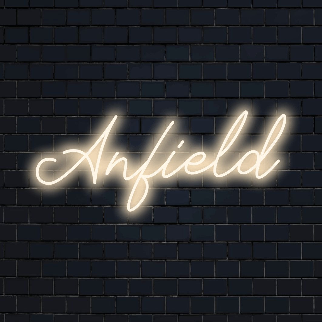 Anfield Neon Light with glowing neon text on dark brick wall