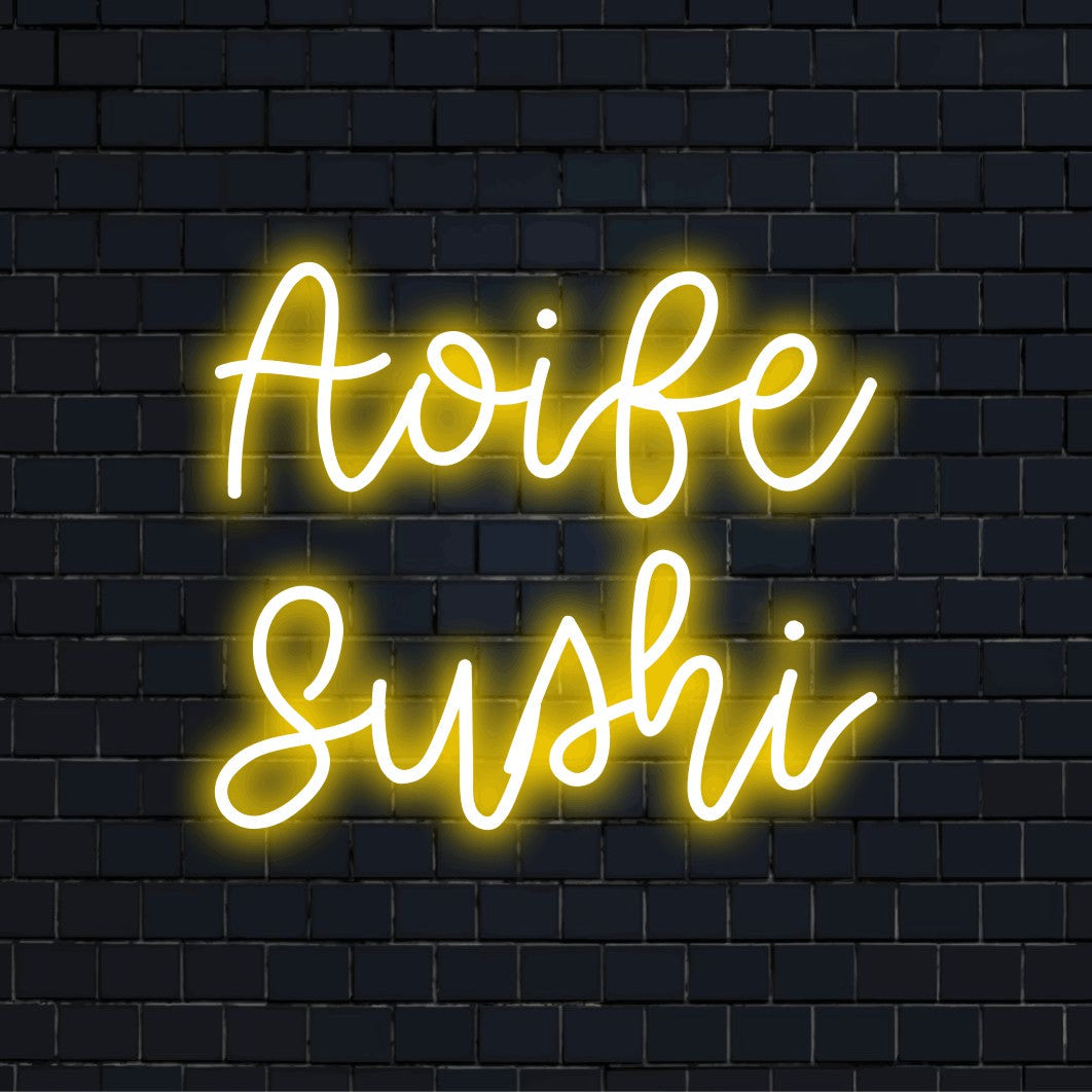 Aoife Sushi Personalized Neon Light with glowing lettering on black brick background
