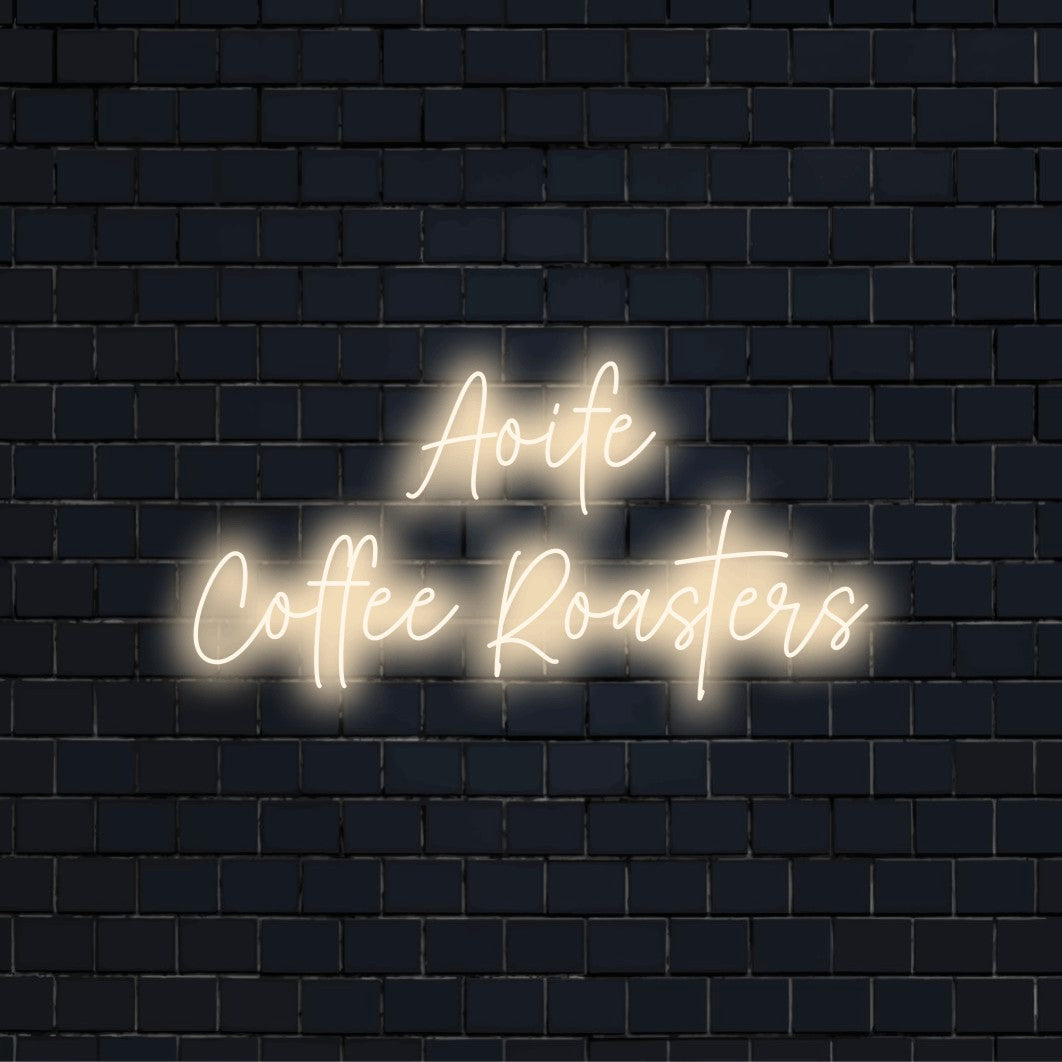 Aoife Coffee Roasters Personalized LED Neon Sign, soft neon glow on dark brick wall