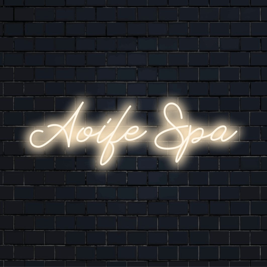 Aoife Spa Personalized LED Neon Sign, bright LED glow on dark brick background