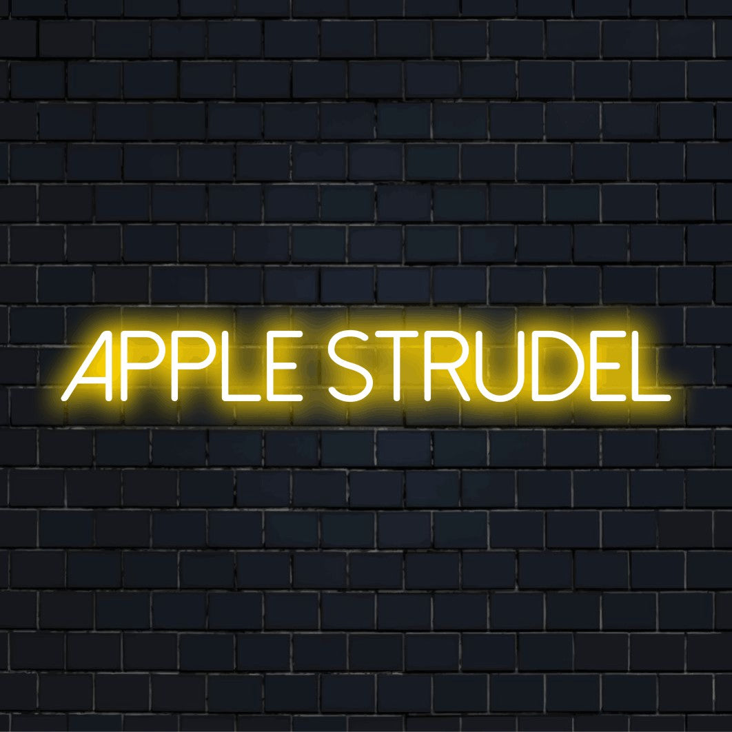 Apple Strudel Neon Sign, glowing lettering against black brick wall
