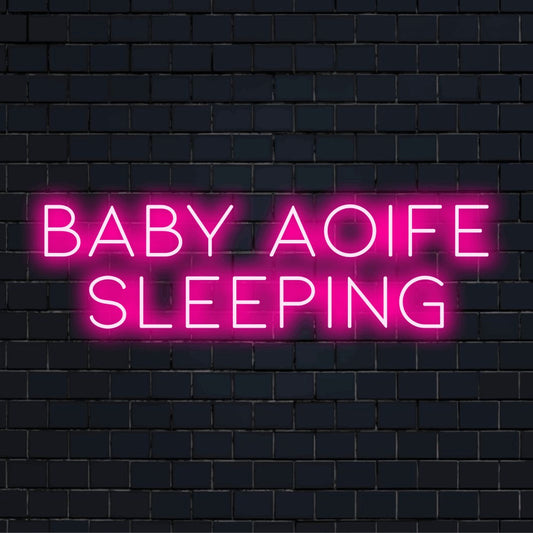 Baby Aoife Sleeping Custom Name Neon Sign, neon text light on black brick background
