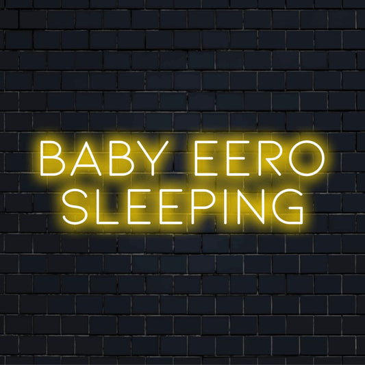 Baby Eero Sleeping Custom Name Neon Sign, soft neon glow against black brick wall