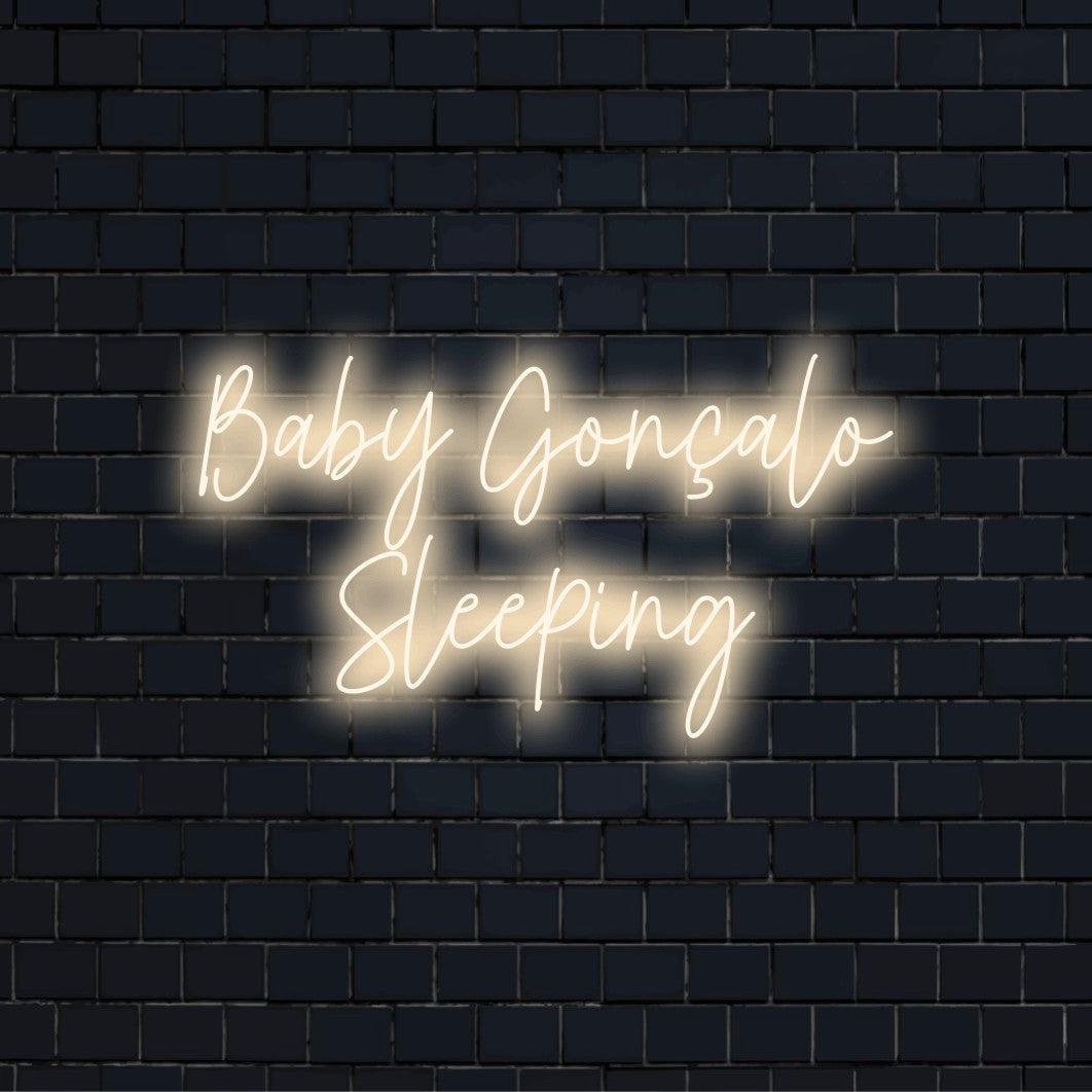 Baby Goncalo Sleeping Personalized LED Neon Sign, glowing neon text on black brick background