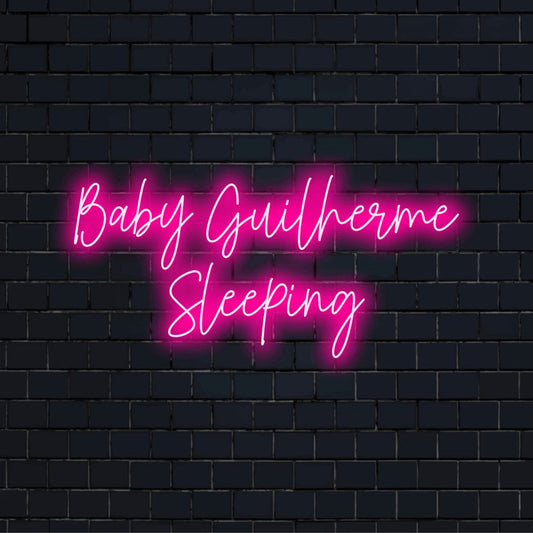 Baby Guilherme Sleeping Custom Name Neon Sign, bright LED glow against black brick wall