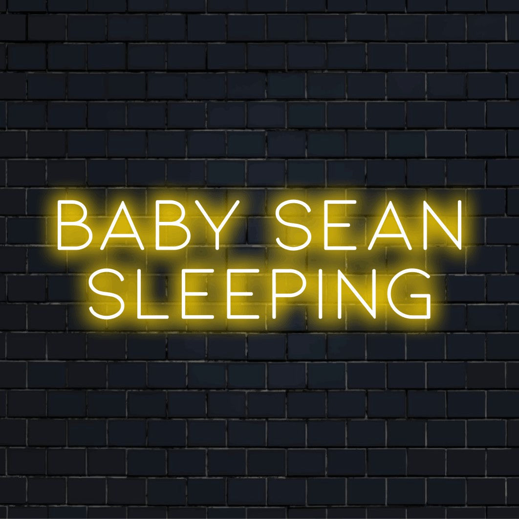 Baby Sean Sleeping Custom Name Neon Sign, bright neon glow on dark brick background