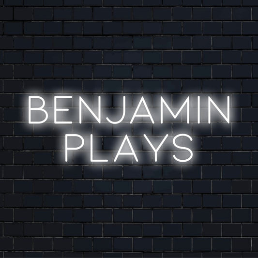 Benjamin Plays Personalized LED Neon Sign, bright neon glow against black brick wall