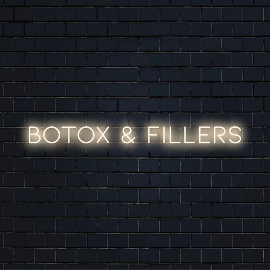 Botox Fillers Neon Sign, bright neon glow against black brick wall