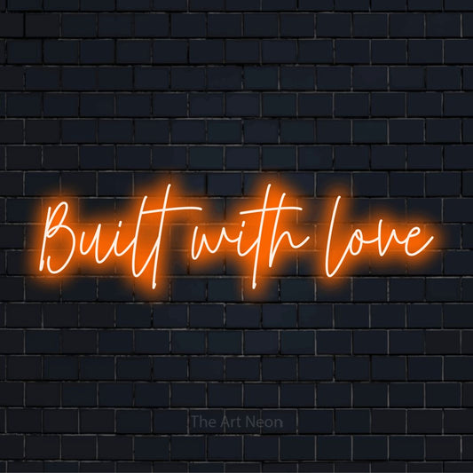 "Built With Love" LED neon sign on a black brick wall