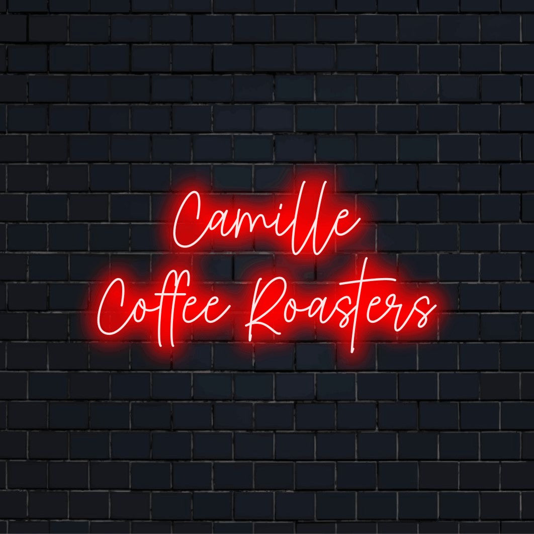 Camille Coffee Roasters Custom Name Neon Sign, neon text light on dark brick wall