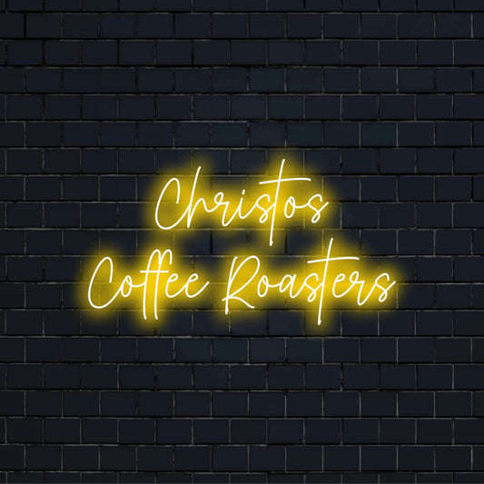 Christos Coffee Roasters Custom Name Neon Sign, bright neon lettering on dark brick wall