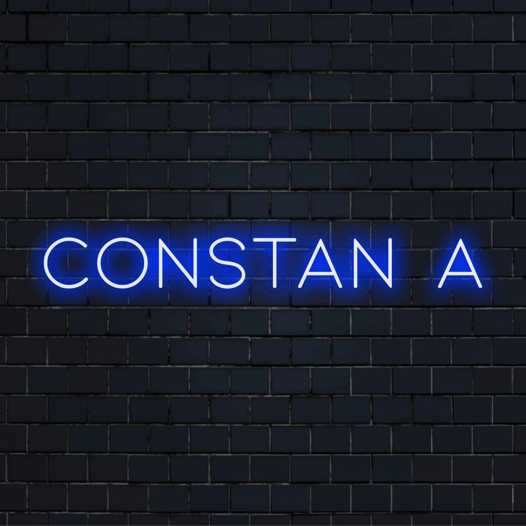 Constan A Neon Light with bright LED glow against black brick wall