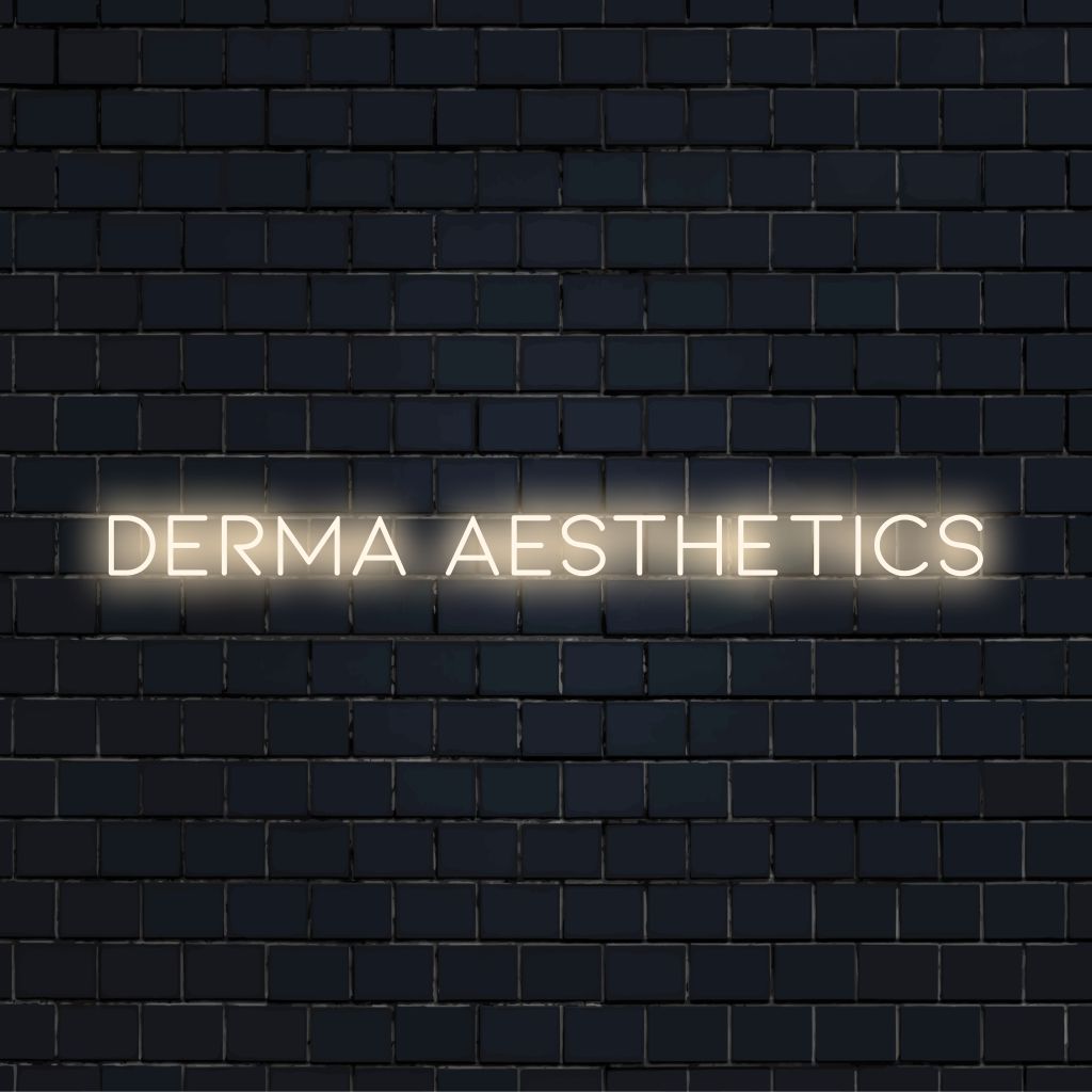 Derma Aesthetics Neon Sign, glowing neon text against black brick wall