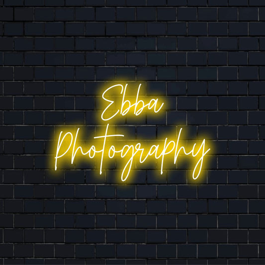 Ebba Photography Custom Name Neon Sign, bright LED glow on dark brick wall