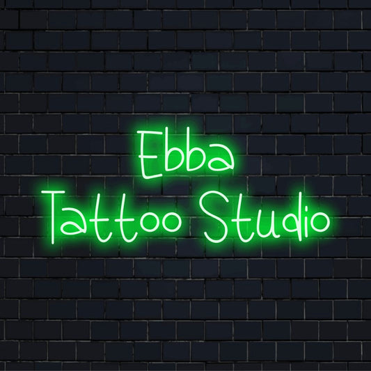 Ebba Tattoo Studio Personalized LED Neon Sign, bright neon lettering on dark brick wall