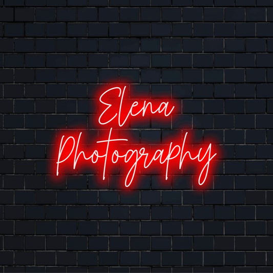 Elena Photography Custom Name Neon Sign, bright neon lettering on dark brick wall