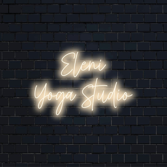 Eleni Yoga Studio Custom Name Neon Sign, glowing neon text against black brick wall