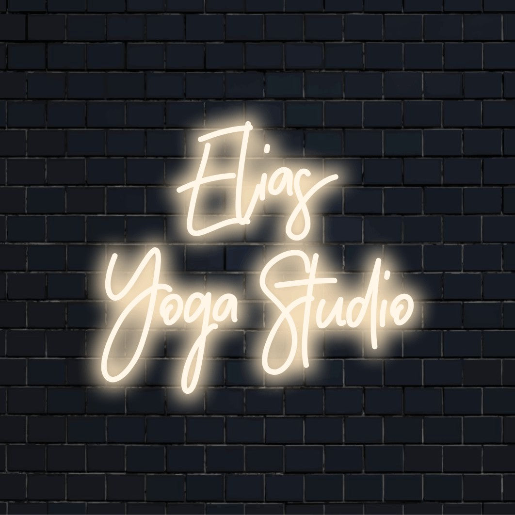 Elias Yoga Studio Personalized Neon Light with bright LED glow on dark brick background