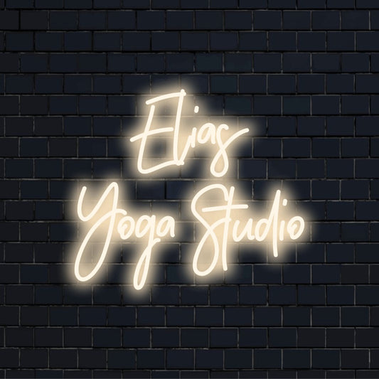 Elias Yoga Studio Personalized Neon Light with bright LED glow on dark brick background