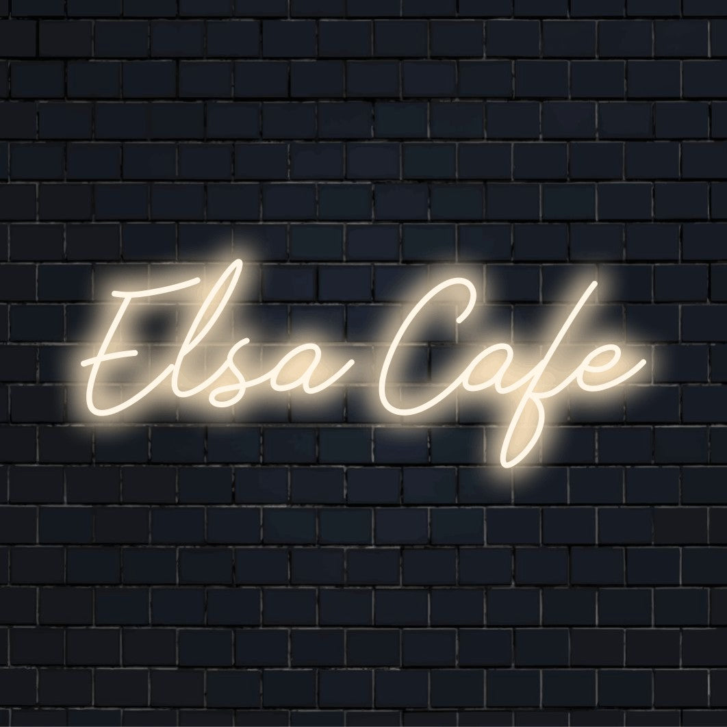 Elsa Cafe Custom Name Neon Sign, bright neon glow against brick backdrop