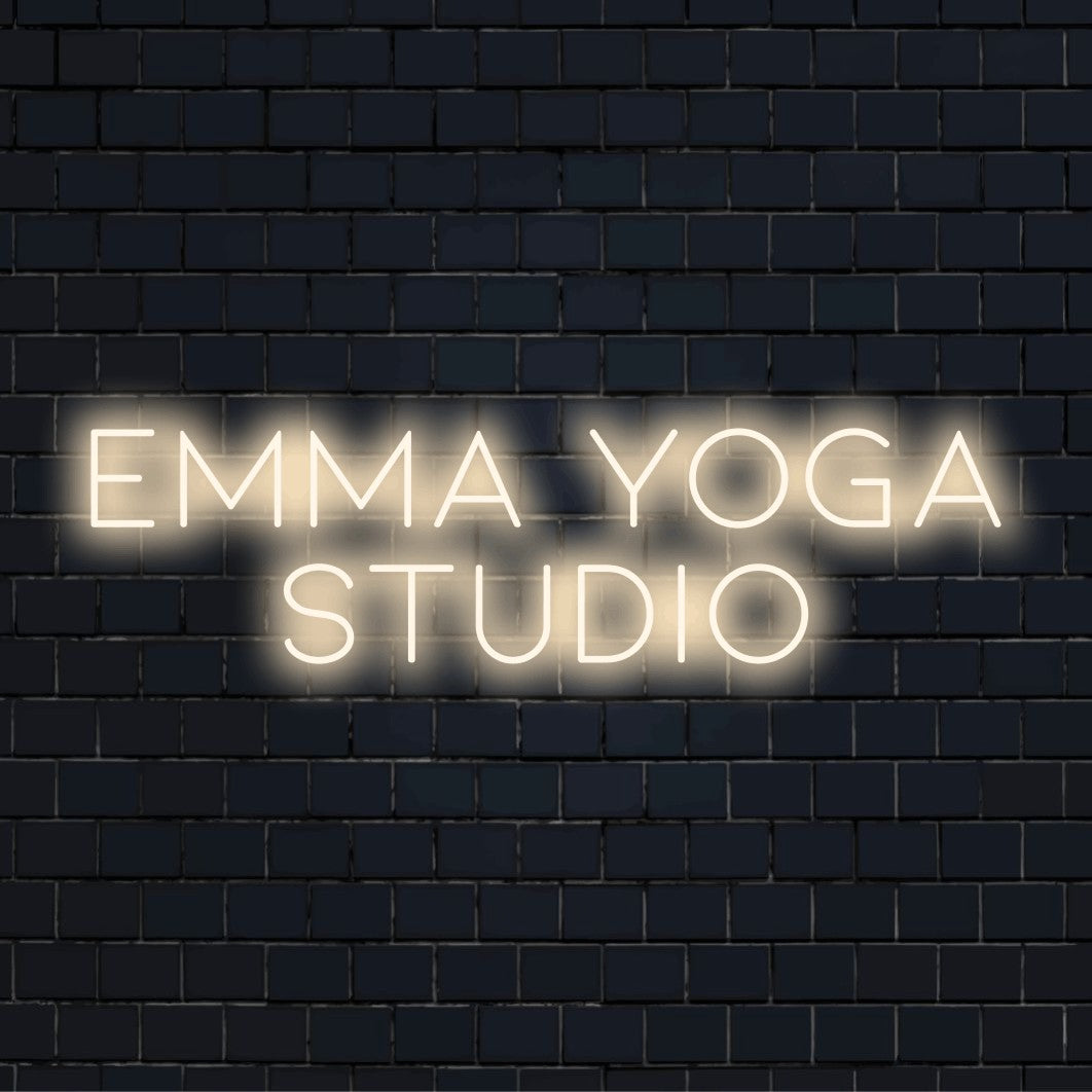 Emma Yoga Studio Personalized LED Neon Sign, neon text light on dark brick wall