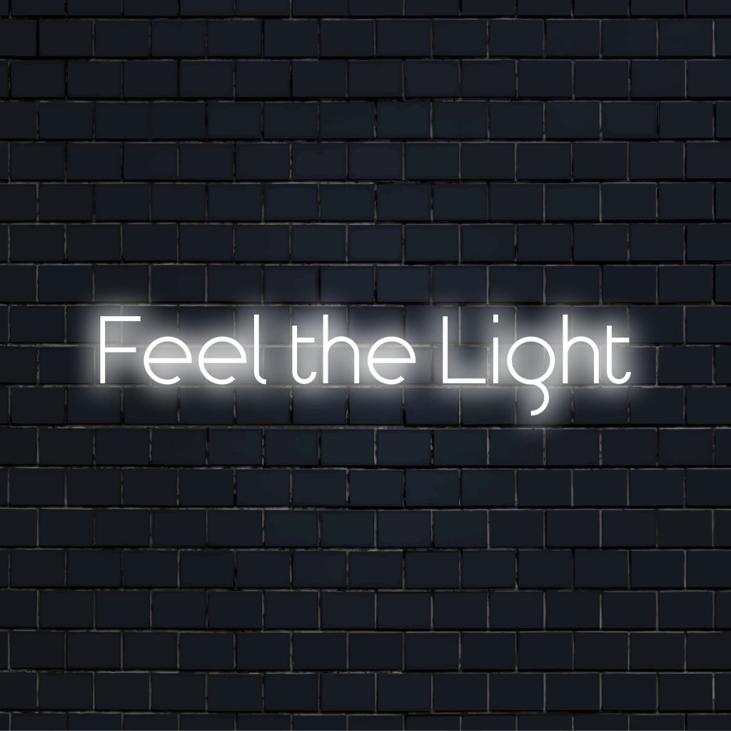 Feel The Light Neon Sign, glowing wall decor against brick backdrop