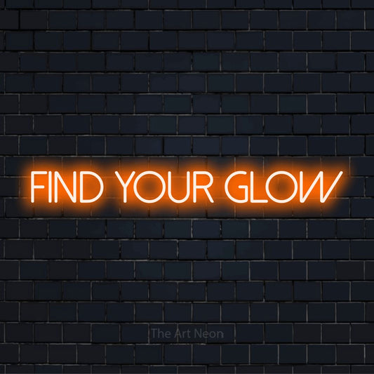 "Find Your Glow" neon text design on a black brick wall