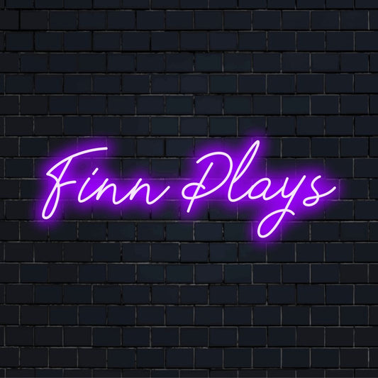 Finn Plays Custom Name Neon Sign, bright LED glow on dark brick background