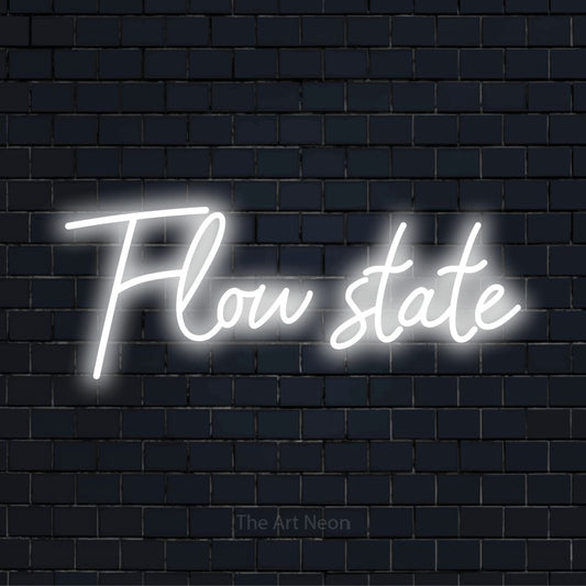 "Flow State" glowing LED neon sign on a black brick wall