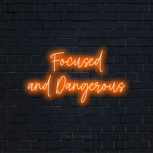 "Focused And Dangerous" neon text design on a black brick wall