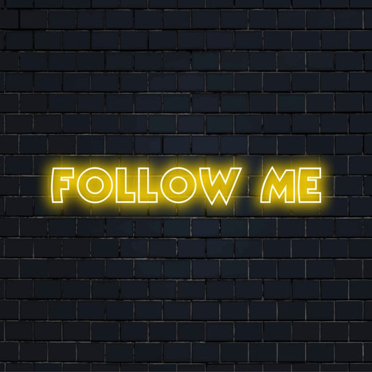 Follow Me Neon Sign, bright neon lettering against brick backdrop