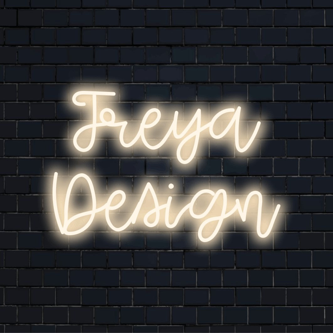 Freya Design Custom Name Neon Sign, glowing wall decor on black brick background