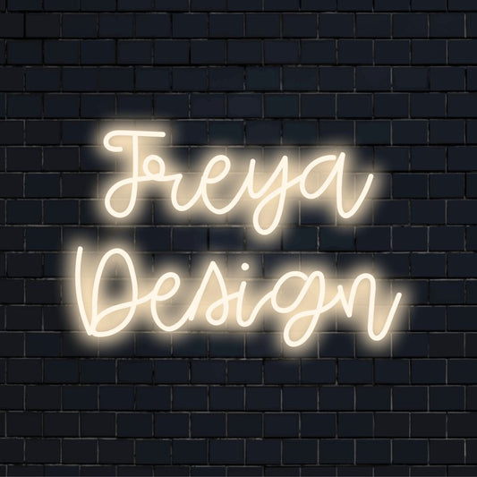 Freya Design Custom Name Neon Sign, glowing wall decor on black brick background