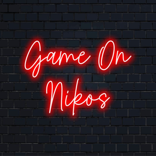 Game On Nikos Custom Name Neon Sign, bright LED glow on dark brick wall