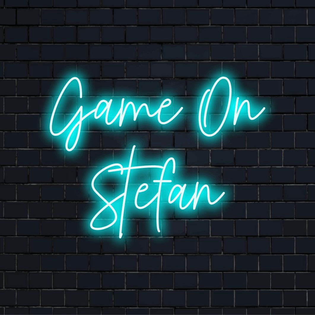 Game On Stefan Custom Name Neon Sign, glowing lettering on dark brick background