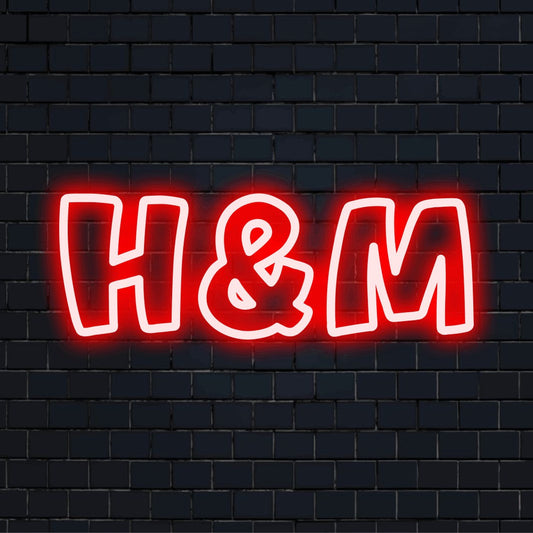H M LED Neon Sign, bright LED glow on dark brick background