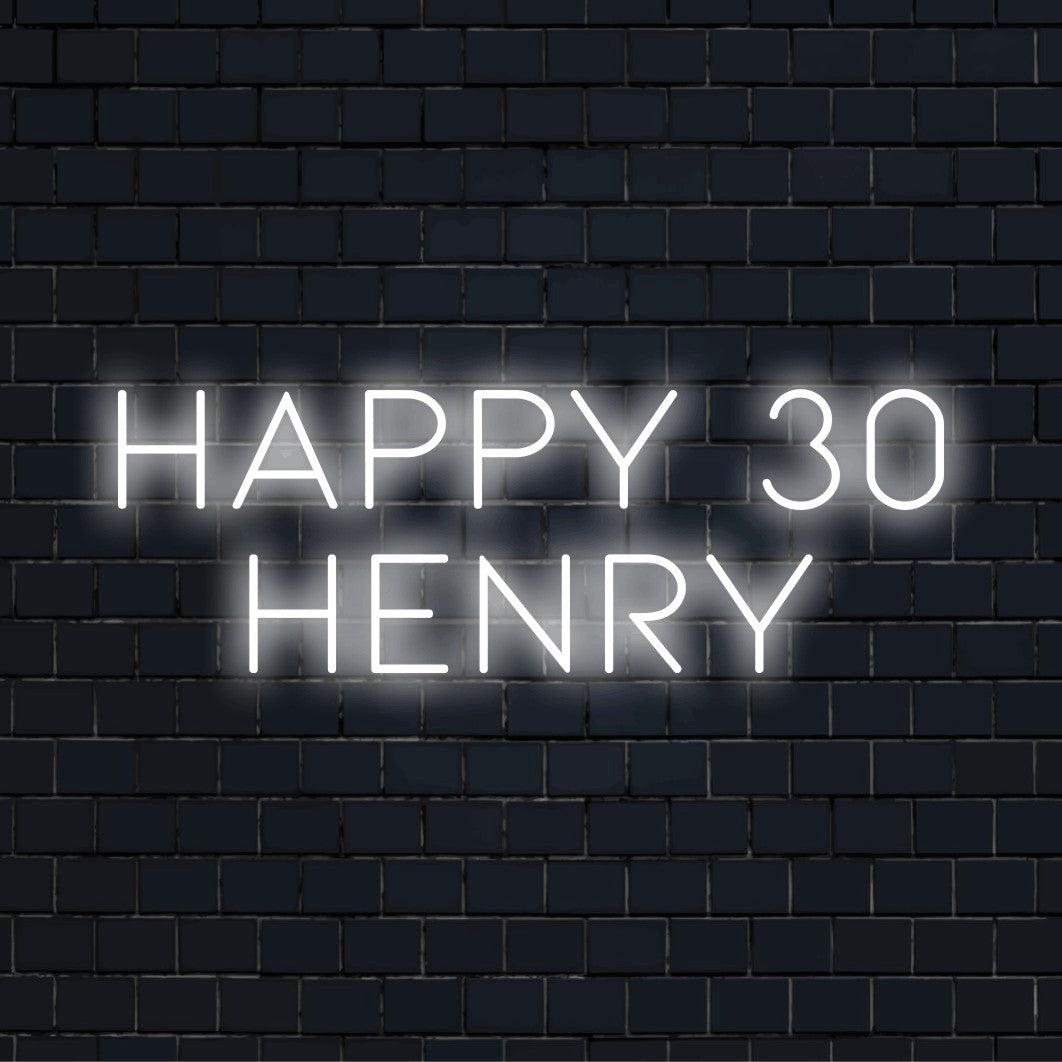 Happy 30 Henry Custom Name Neon Sign, bright neon lettering on dark brick wall