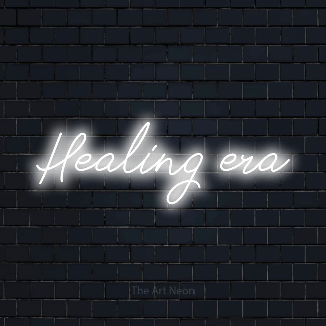 "Healing Era" LED neon sign on a black brick wall