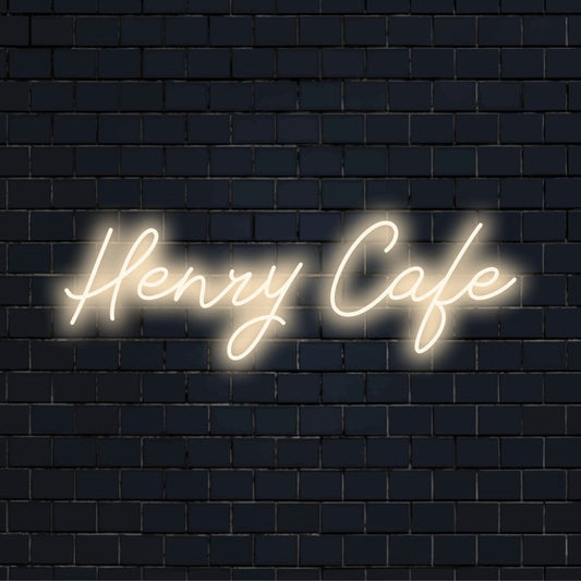 Henry Cafe Custom Name Neon Sign, bright neon lettering on dark brick wall
