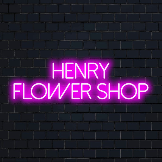 Henry Flower Shop Personalized Neon Light with neon text light against brick backdrop
